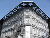 Building with cut-out metal sign on roof reading “Terror House”