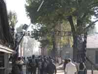 Auschwitz entrance gate with ironwork reading “Arbeit macht Frei”