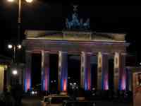 Back of Brandenburg Gate lit in red and blue