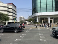 People not crossing with a green pedestrian signal