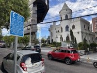 Modern building overshadowing church